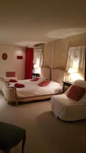 a hotel room with two beds with red curtains at Chambres touristiques La Cour Des Hôtes in Obernai