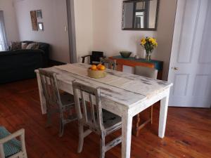 a dining room table with a bowl of oranges on it at Windsor Cottage in Barberton