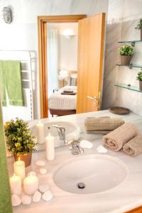 a bathroom counter with a sink and a mirror at Athens luxurious apartment - sea view! in Athens