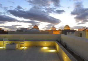 a rooftop terrace with a view of the city at Dar ALOUINI in Kairouan