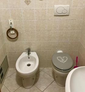 a bathroom with a toilet and a bidet at Little art house in Gaeta