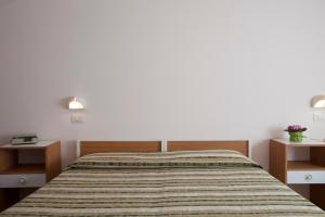 Postel nebo postele na pokoji v ubytování Hotel Cecco