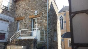 a building with a staircase on the side of it at Au Pigeon Blanc in Andouillé