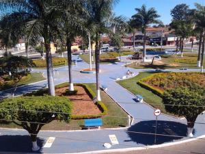 a park with palm trees and a street at Hotel Imperador in Caldas Novas