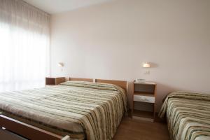 Postel nebo postele na pokoji v ubytování Hotel Cecco