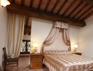 a bedroom with a bed with a canopy at Castel di Pugna in Siena
