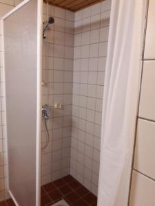a bathroom with a shower with a shower curtain at Hamina Orange Apartments Ilves in Hamina +21 photos