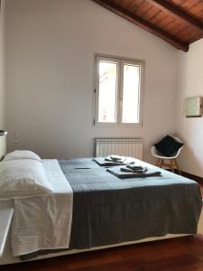 una camera bianca con un grande letto con finestra di Casa Falegnami 20.19 a Bologna
