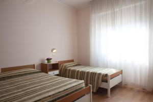 Postel nebo postele na pokoji v ubytování Hotel Cecco