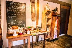 a table with food and a chalkboard on a wall at Vale da Vacaria in Serra do Cipo