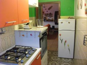 a kitchen with a stove and a refrigerator at La Riva in Porto Recanati