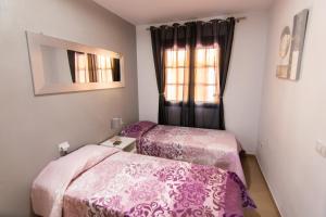 En eller flere senge i et værelse på Casa Mariposa + 14 billeder