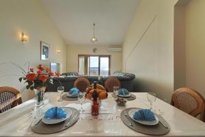 a dining room with a table and a couch at Villa Vukic in Vrsi