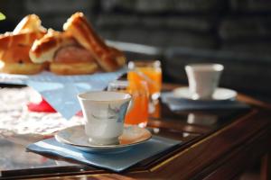 a tray with a coffee cup and pastries on a table at Villa Vukic in Vrsi