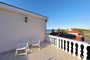 two chairs on a balcony with a view of the ocean at Villa Vukic in Vrsi