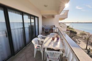 a balcony with a table and chairs and the ocean at Villa Vukic in Vrsi