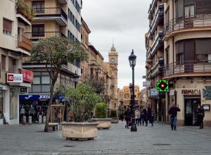 a city street with a clock tower in the distance at Homely Salamanca in Salamanca