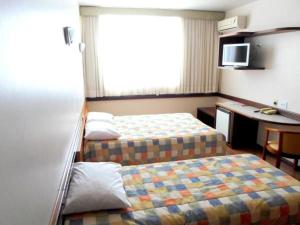 Ein Bett oder Betten in einem Zimmer der Unterkunft Atalaia Palace Hotel