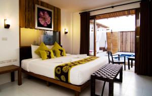 a bedroom with a large bed with yellow pillows at Lawana Escape in Pran Buri