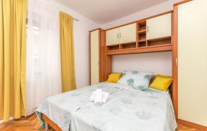 a bedroom with a bed with a towel on it at Apartment Pavla with pool in Zadar
