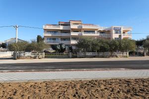 an empty street in front of a building at Villa Vukic in Vrsi