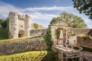 an old castle with a stone wall and a bridge at Charter House in Newport