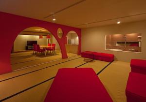 a bowling alley with red chairs and a table at Address Nozawa Suite / Vacation STAY 22748 in Nozawa Onsen