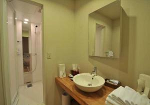 a bathroom with a white sink and a shower at Address Nozawa Suite / Vacation STAY 22748 in Nozawa Onsen
