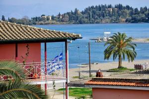 a house with a view of a beach and water at Hotel Orpheus in Gouvia