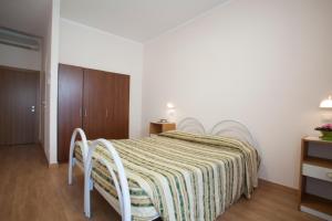 Postel nebo postele na pokoji v ubytování Hotel Cecco