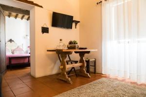 una mesa en una habitación con TV en la pared en Carrança Lounge en Évora