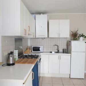a white kitchen with white cabinets and a sink at Volare...oh...oh in Cernobbio +18 photos