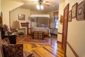 a bedroom with a bed and a living room at Inn at Herr Ridge in Gettysburg