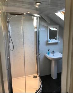 a bathroom with a shower and a sink at The Royal George Staithes in Staithes