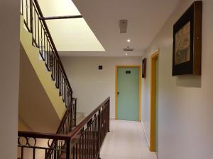 a hallway with stairs and a blue door at De UPTOWN Hotel @ Subang Jaya in Subang Jaya