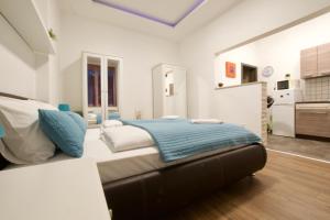 a bedroom with a large bed with a blue blanket at Standard Apartment by Hi5 -Baross Square in Budapest