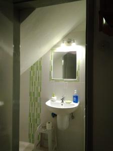 a bathroom with a sink and a mirror at Grandma's House in Penamacor