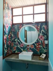 a bathroom with a mirror and a sink at CasaBosque in Tarapoto