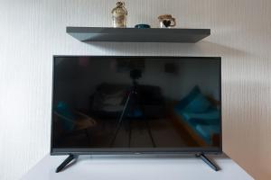 a flat screen tv with a camera on a wall at Ferienwohnung Maria Laach 2 in Glees