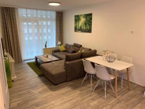 a living room with a couch and a table at Mariposa inclusive Pool und Sauna in Bad Harzburg