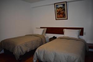 Ліжко або ліжка в номері Casa De Luz Hotel
