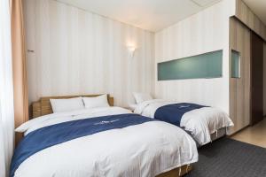 Postel nebo postele na pokoji v ubytování Incheon Aiport Airrelax hotel