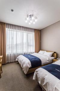 Postel nebo postele na pokoji v ubytování Incheon Aiport Airrelax hotel
