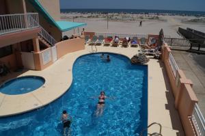 a woman in a swimming pool at a resort at Beau Rivage Beach Resort in Wildwood Crest