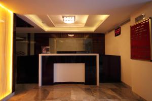 a dining room with a table and a sign on the wall at Hotel Furaat Inn in Ahmedabad