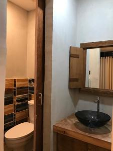a bathroom with a sink and a toilet at Michel'inn Coron in Coron