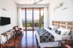 a bedroom with a bed and a large window at Kandy Casa by Regus in Kandy
