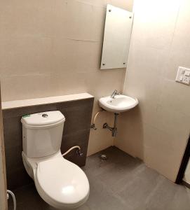 a bathroom with a toilet and a sink at Pride Home in Chandīgarh