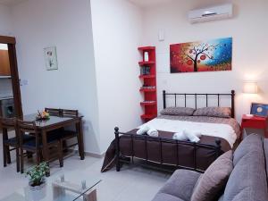 a living room with a bed and a couch at Kerynia Apartments in Paphos