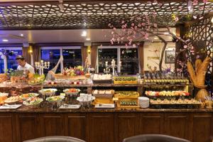 a buffet line with many different types of food at Mon Chéri Cruises in Ha Long